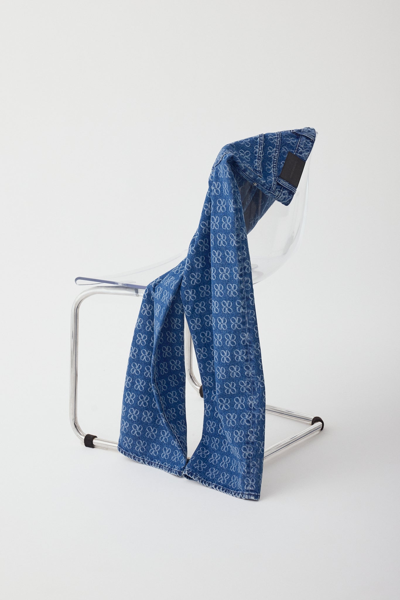 Outland denim Avril jeans in icon dusk slung over chair