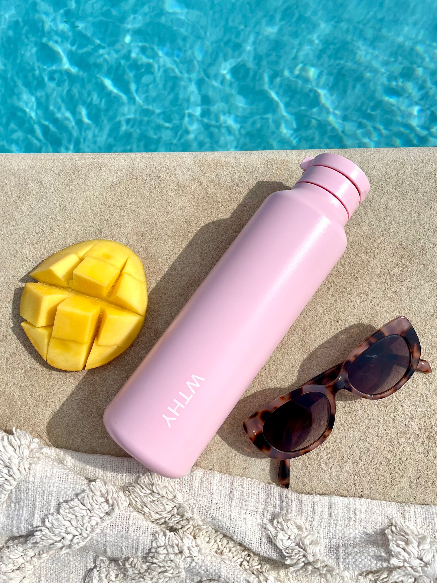 pink worthy drink bottle by pool