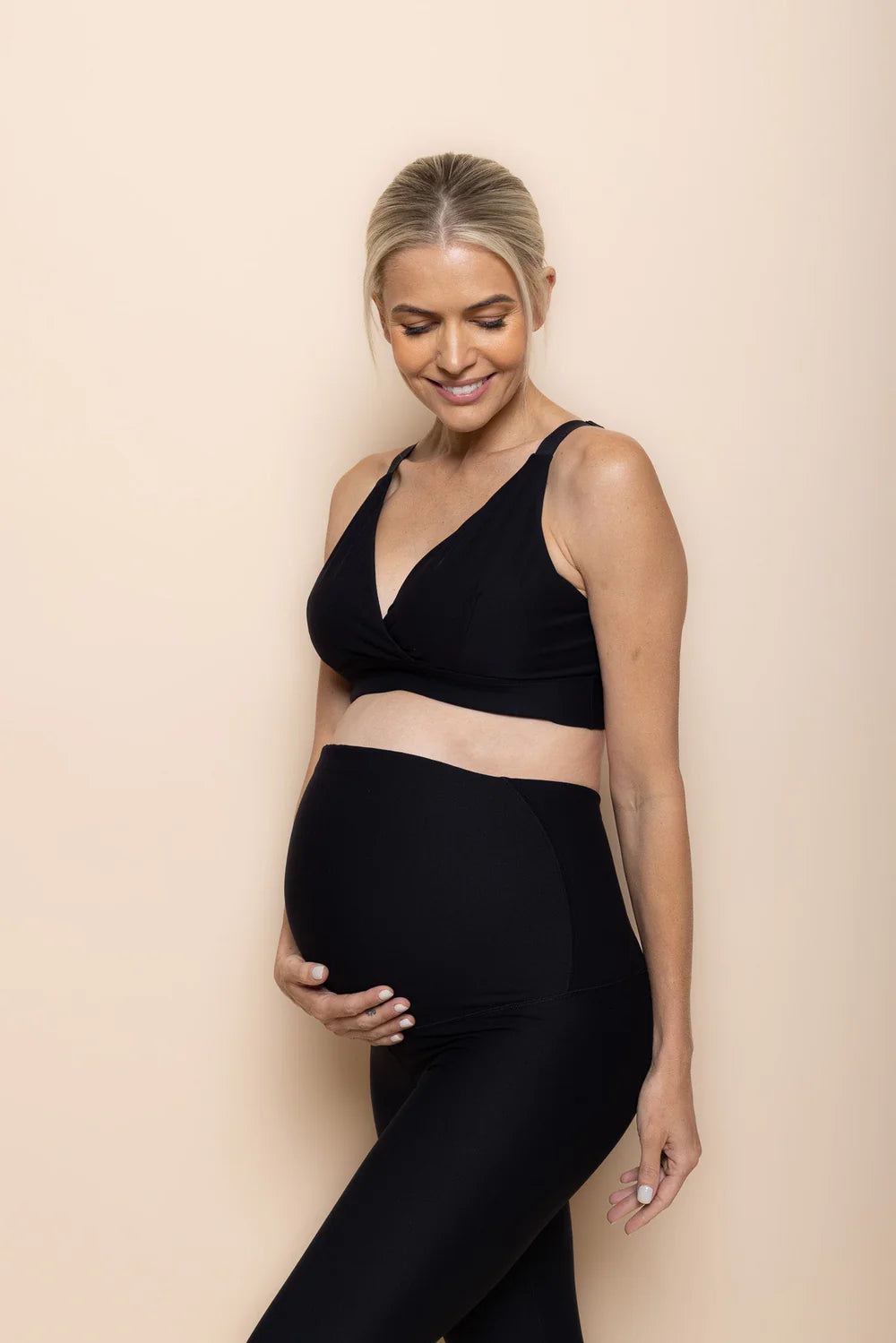 DK Active essence maternity bra in black hand under bump