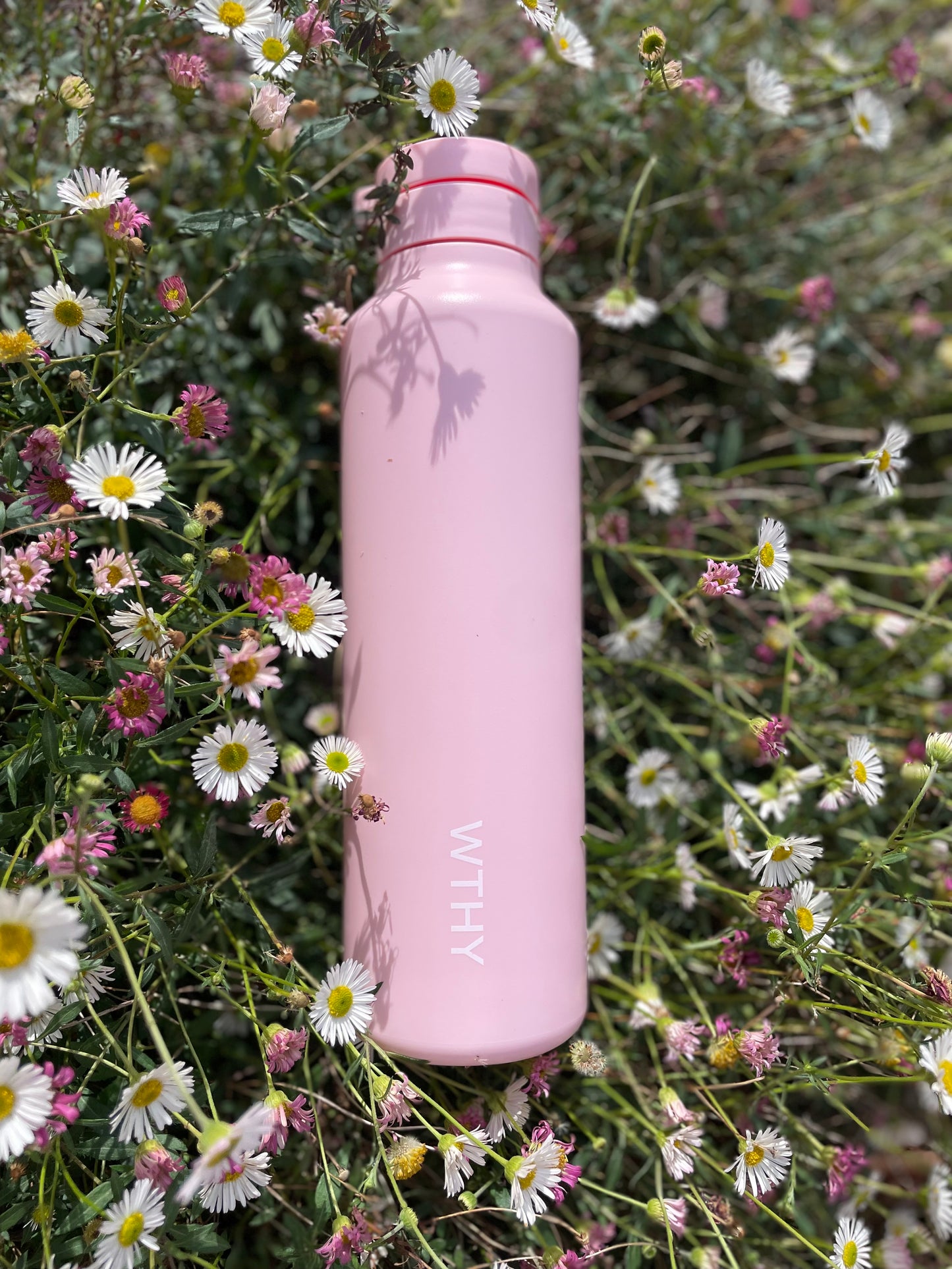 pink worthy drink bottle in field