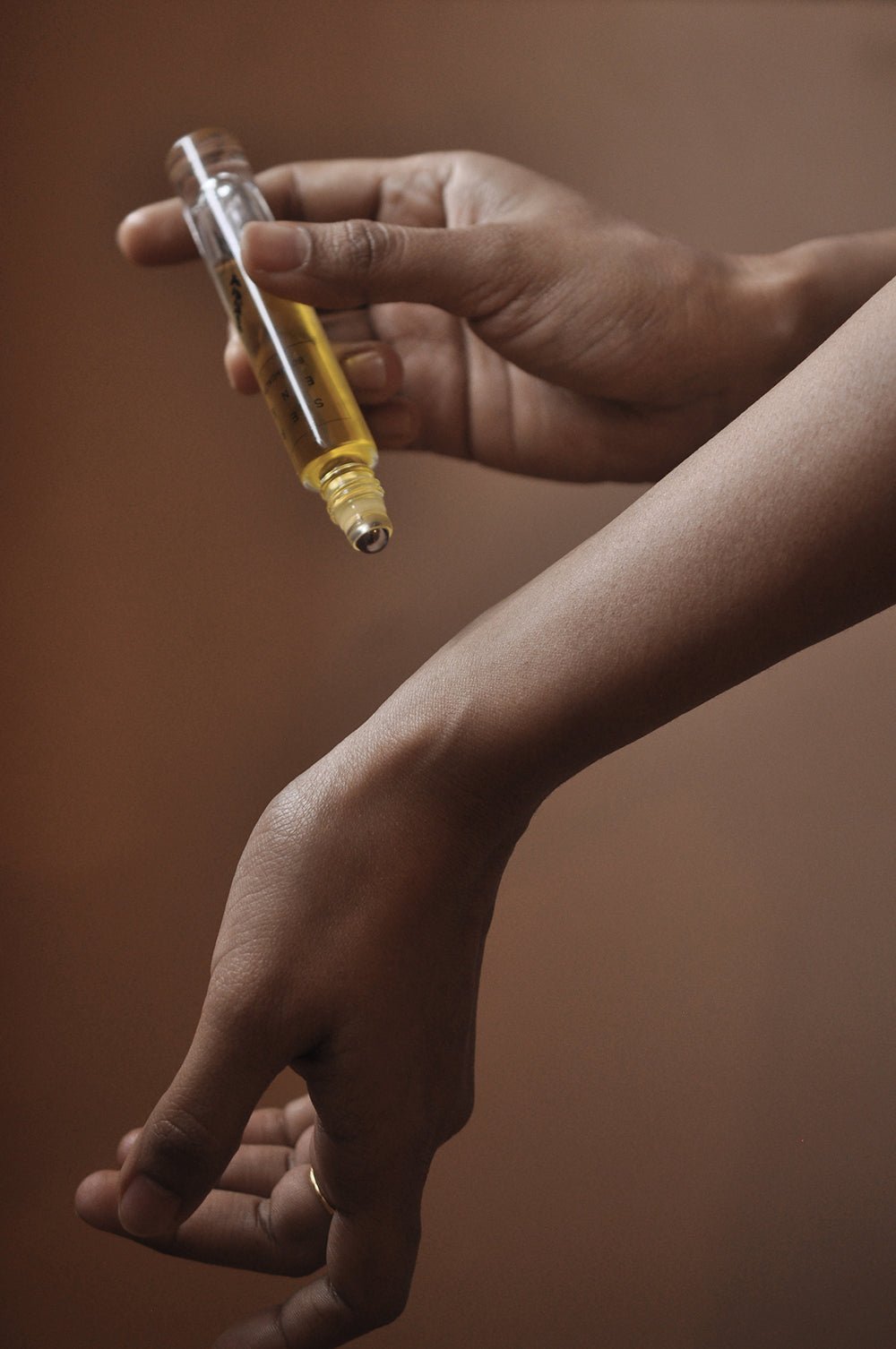 Aware roll on perfume being applied