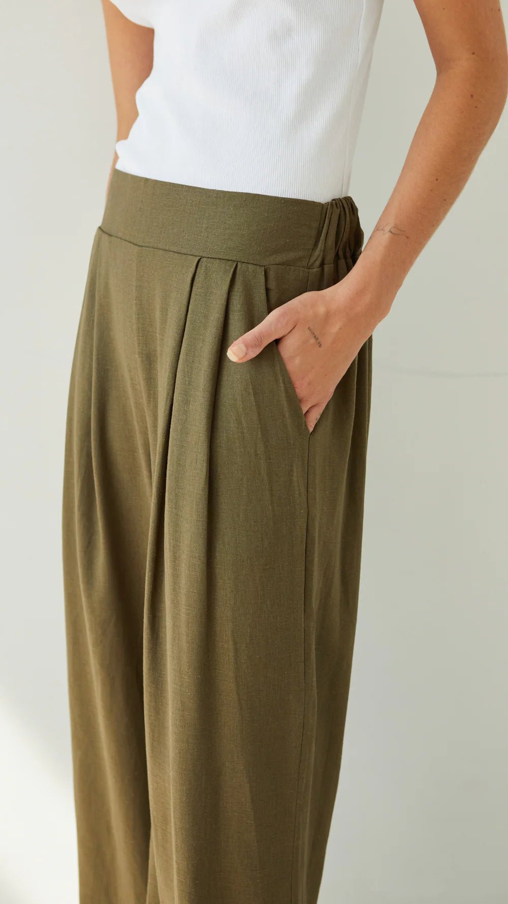 Charli Alexis linen pants in khaki close up hand in pocket