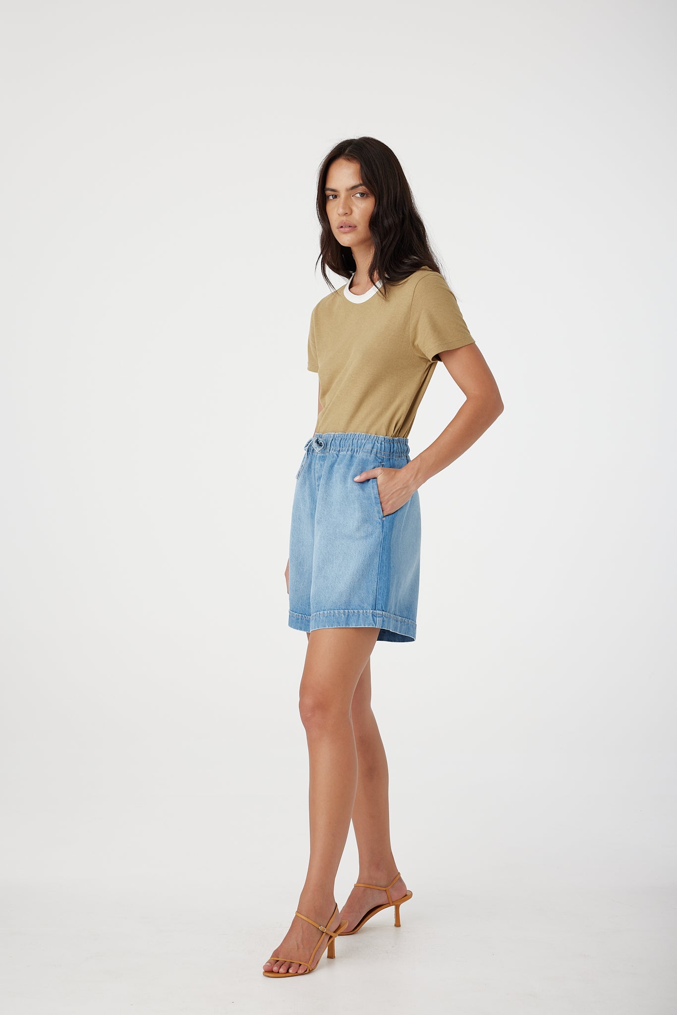 Outland Denim Eden Shorts in Bluejay model's hand in pocket