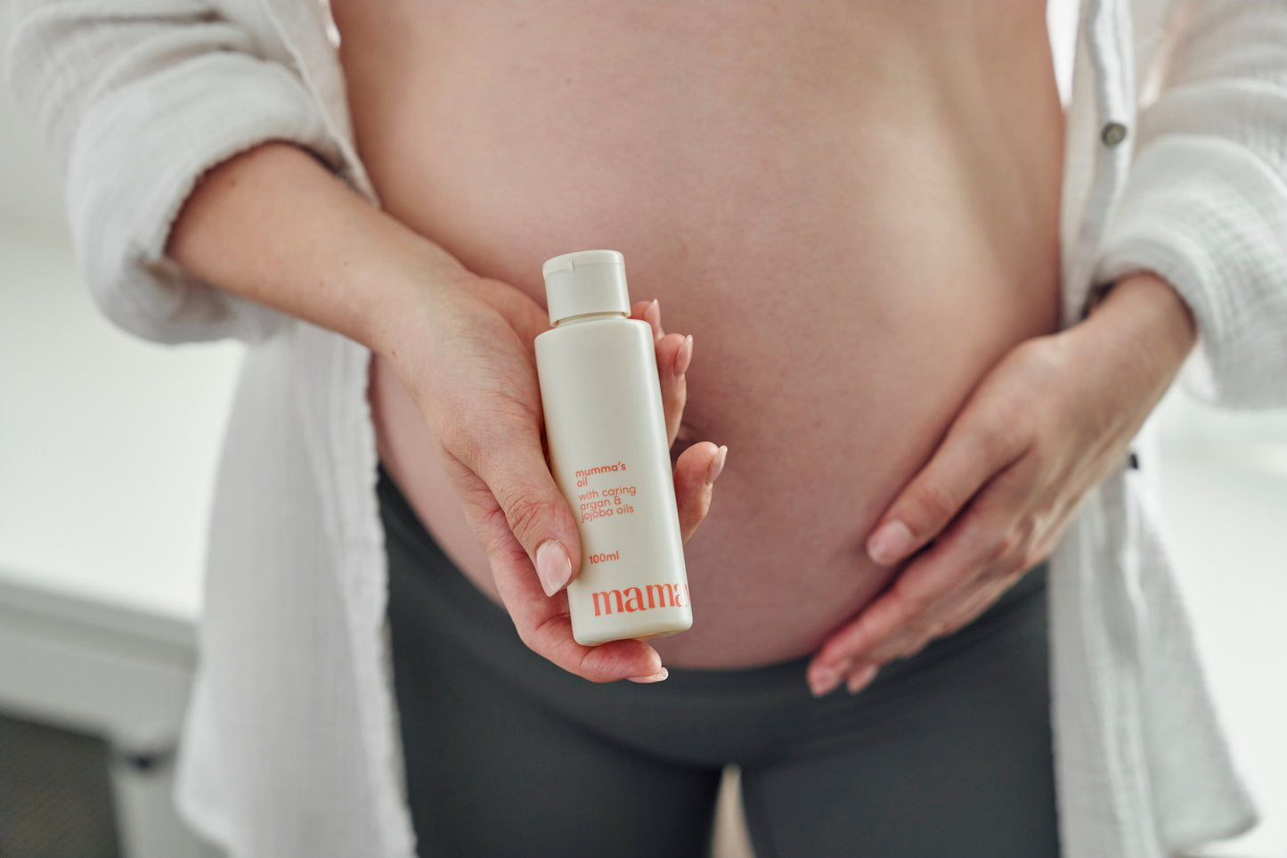 Mumma's body oil with pregnant model