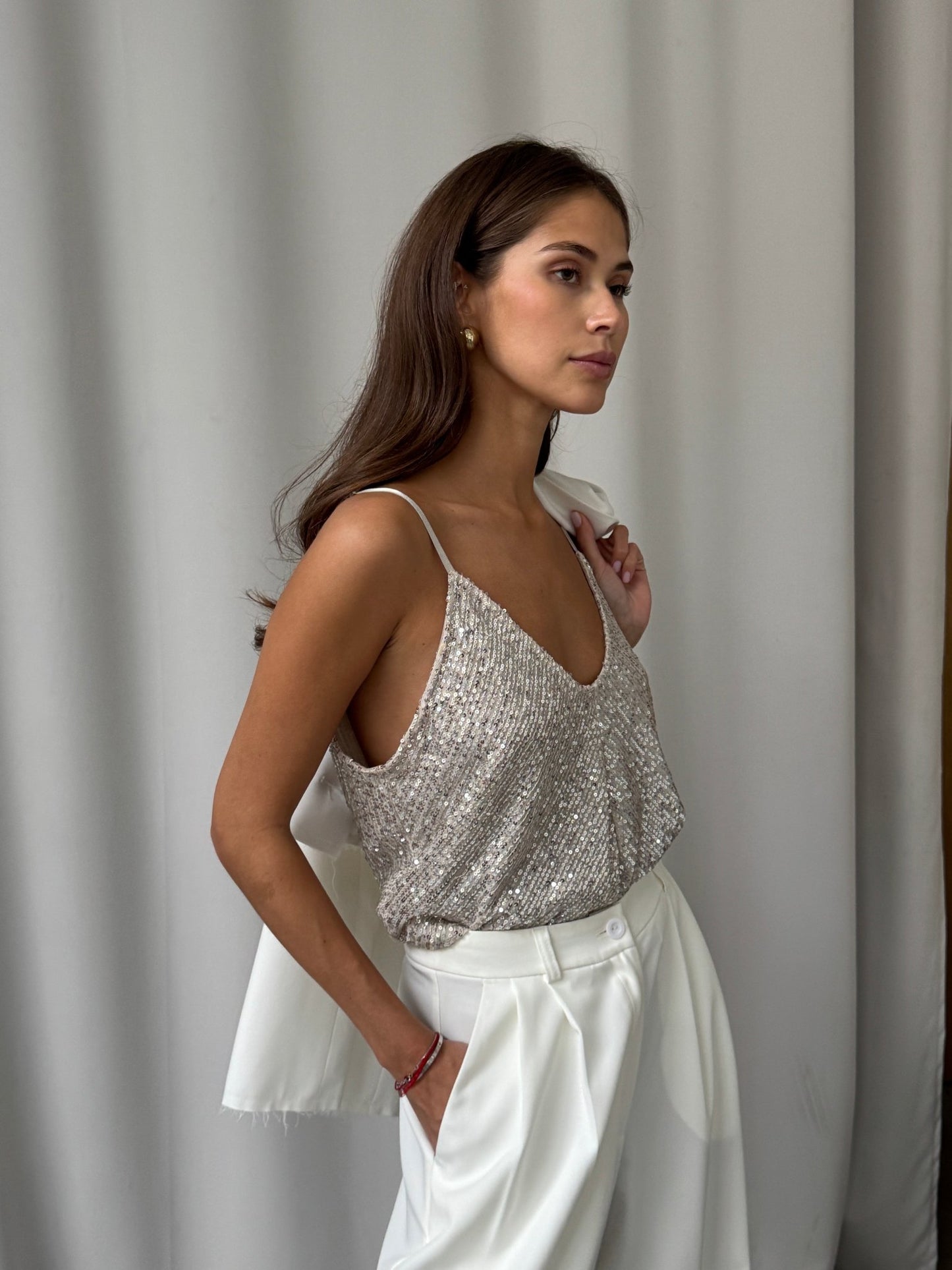 Charli Sienna cami in silver sequin, jacket over shoulder