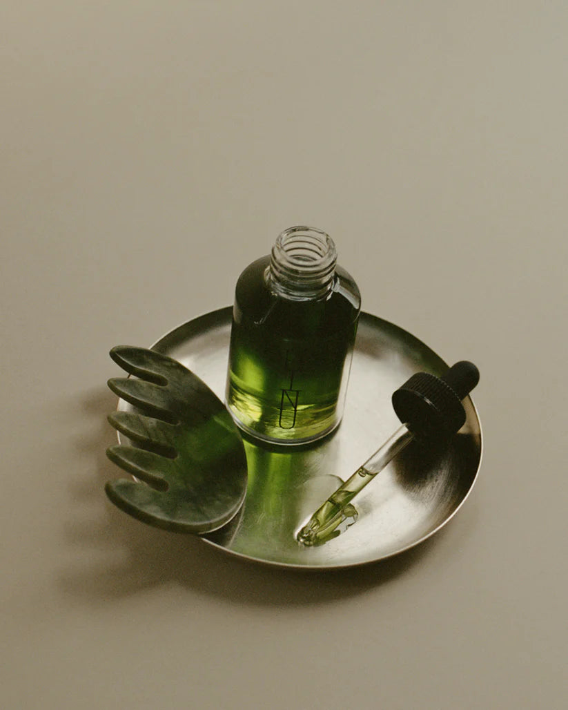 Jade scalp stimulator on tray with oil